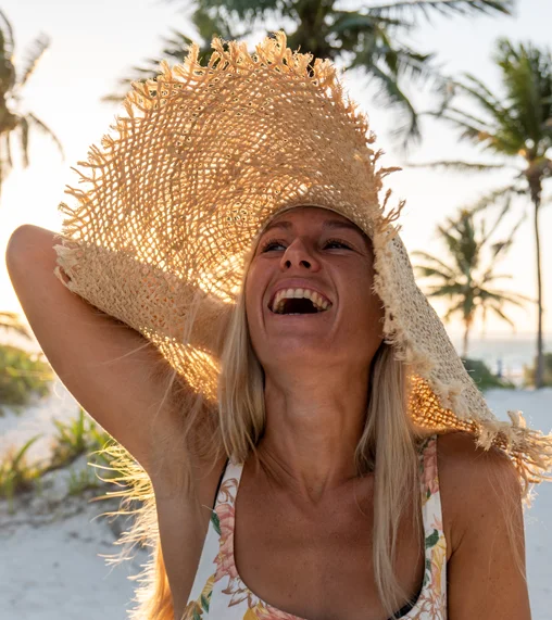 Woman in a straw hat laughing